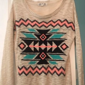 Cream sweater with design on the front